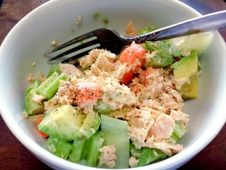 Tuna Salad with paleo mayo, baby carrots, and celery, in a white bowl.